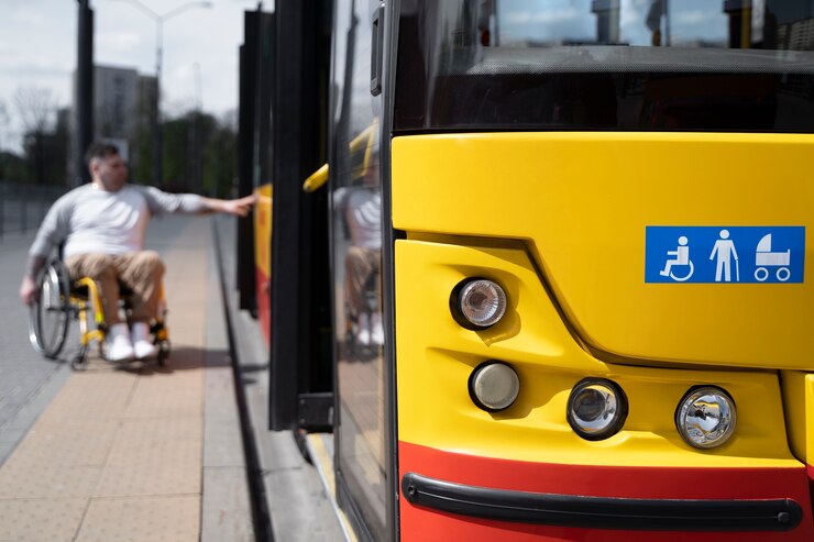 A disabled man boarding a bus